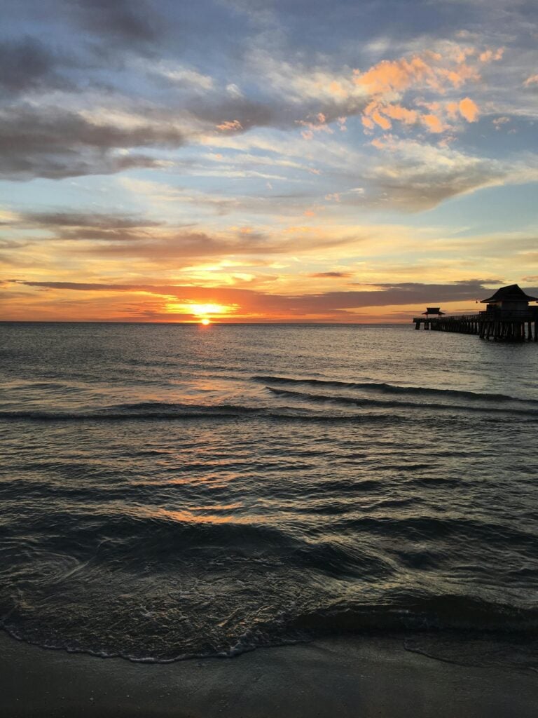 Beautiful sunset over the Gulf of Mexico at Naples Pier, Florida.